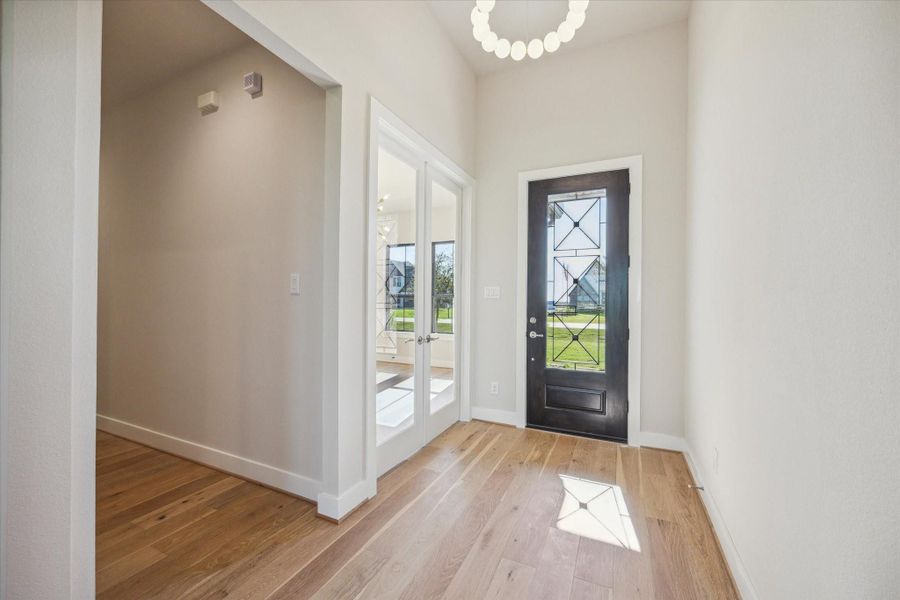Foyer, Home Office/Study found through glass double doors, hallway to Secondary Bedroom (1 of 3), and Utility Room Foyer, Home Office/Study found through glass double doors, hallway to Secondary Bedroom (1 of 3), and Utility Room