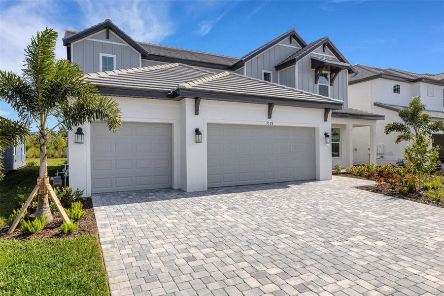 Front exterior of a new home in Hawkstone, Sarasota, FL, highlighting curb appeal (Image 2).