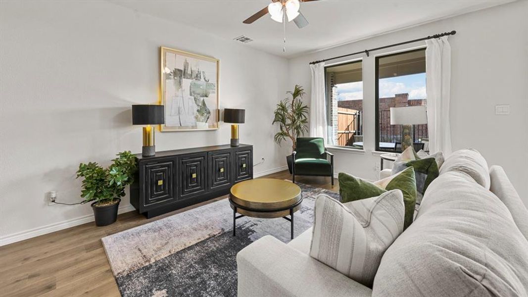 Living area featuring wood finished floors and a ceiling fan