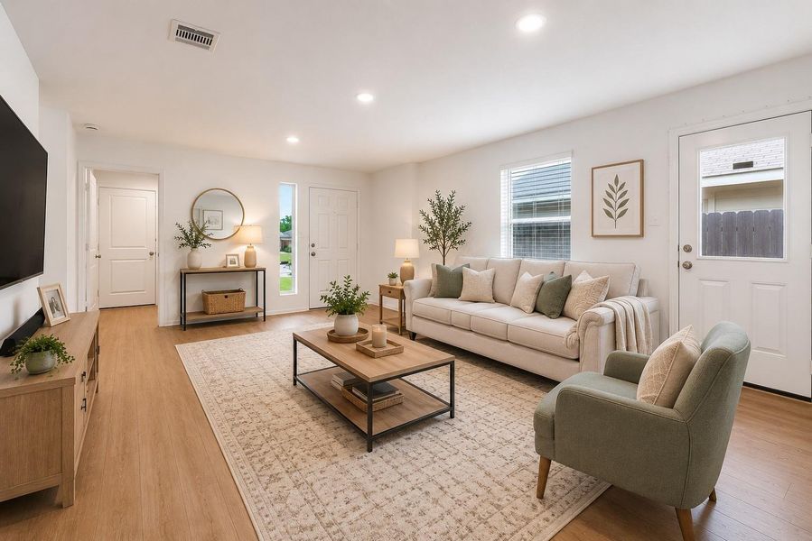 The welcoming family room offers an open-concept design with abundant natural light and seamless flow into the kitchen. (Virtually Staged)
