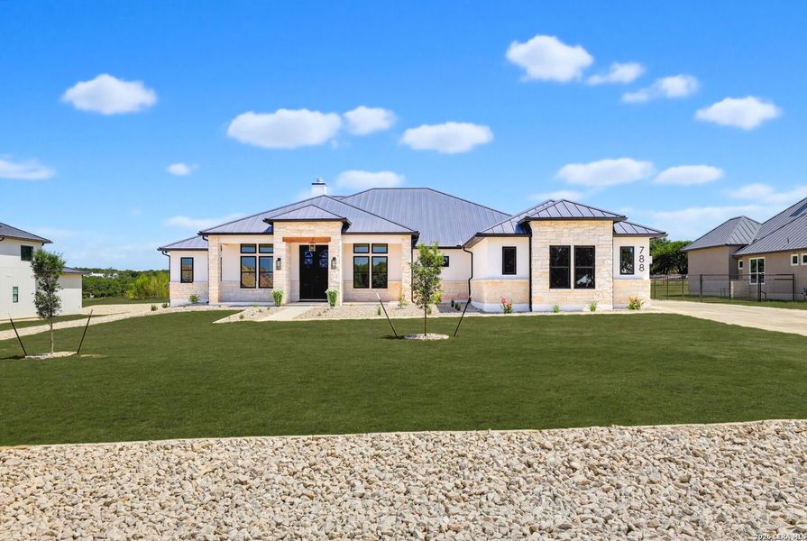 Front exterior of a new home in , Bulverde, TX, highlighting curb appeal (Image 25).