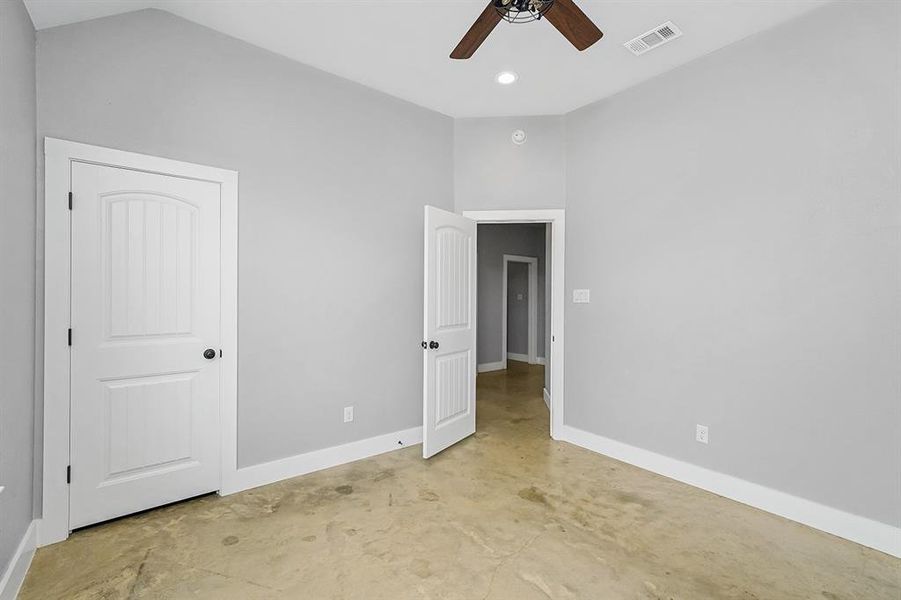 Unfurnished bedroom with baseboards, concrete floors, ceiling fan, and recessed lighting
