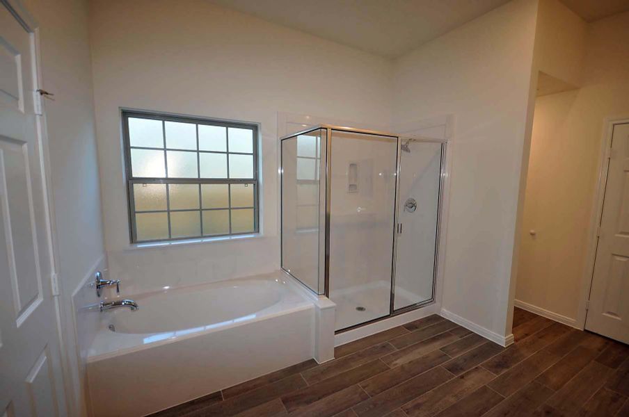 Large shower next to the soaking tub in the master bath.