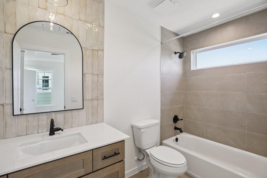 Bathroom featuring shower / tub combination and vanity