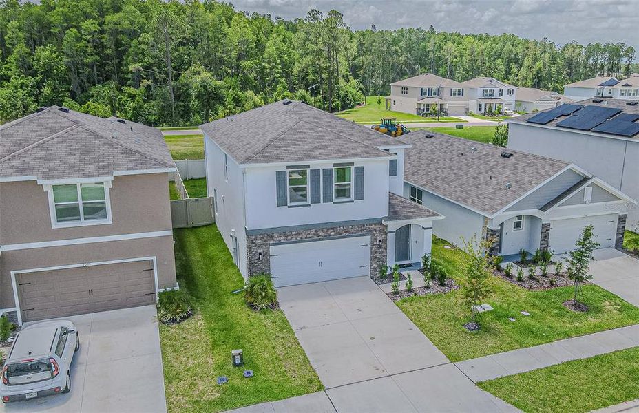 Front exterior of a new home in Deerbrook, Land O' Lakes, FL, highlighting curb appeal (Image 28).