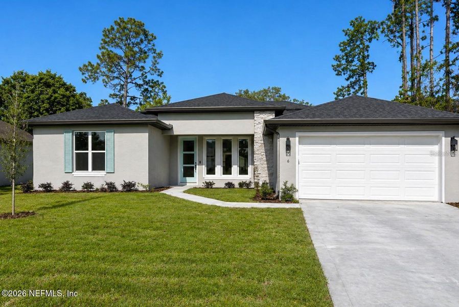 Front exterior of a new home in , Palm Coast, FL, highlighting curb appeal (Image 1). Front exterior of a new home in , Palm Coast, FL, highlighting curb appeal (Image 1).