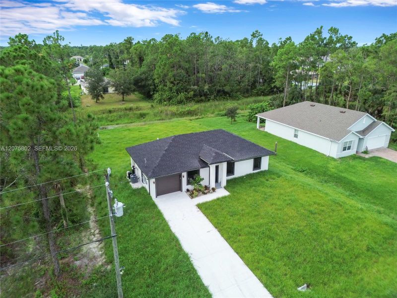 Front exterior of a new home in , Lehigh Acres, FL, highlighting curb appeal (Image 17).