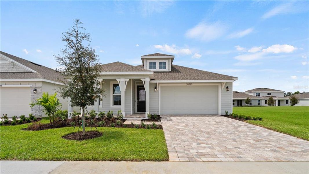 Front exterior of a new home in Trailside, Mount Dora, FL, highlighting curb appeal (Image 18).