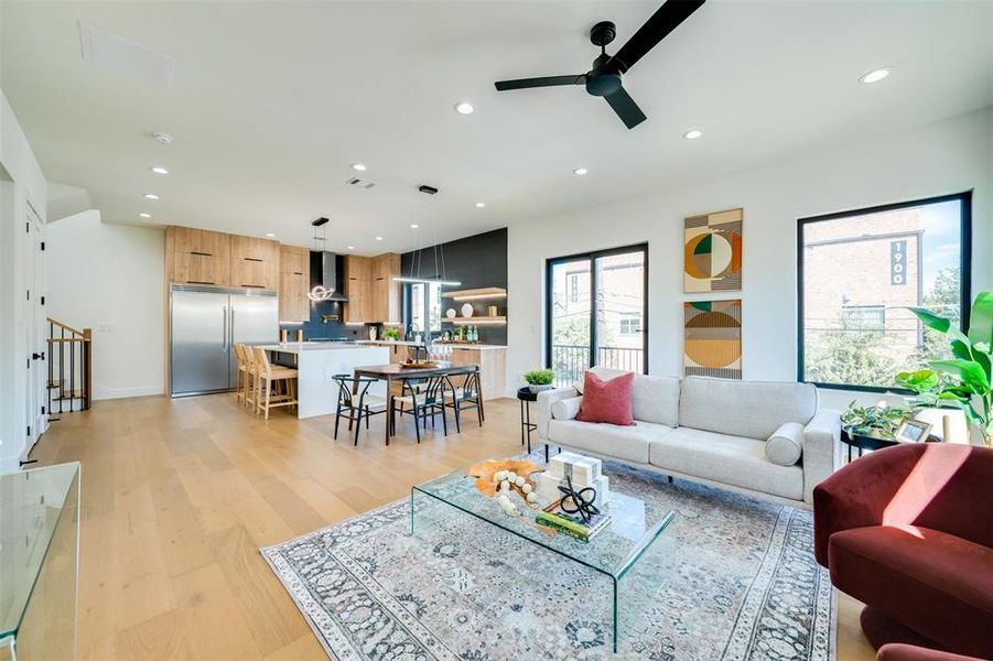 Living room featuring light hardwood / wood-style floors and ceiling fan