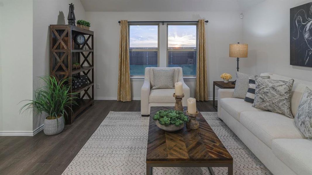 Living room featuring dark wood-style flooring and vaulted ceiling