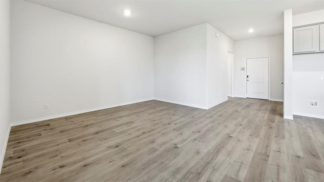 Empty room with light wood-style flooring and recessed lighting Empty room with light wood-style flooring and recessed lighting