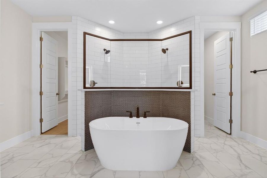 Freestanding soaking tub with dark bronze fixtures Freestanding soaking tub with dark bronze fixtures