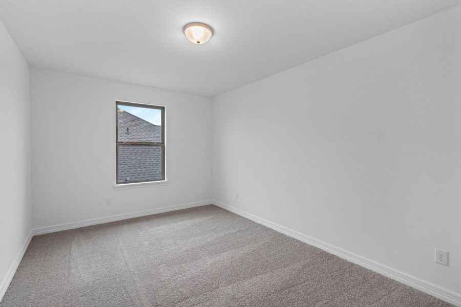 Your secondary bedroom features plush carpet, fresh paint, closet, and a large window that lets in plenty of natural lighting.