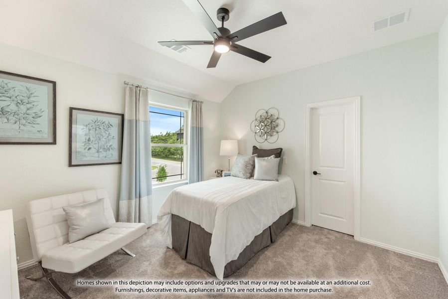 Bedroom with vaulted ceiling, ceiling fan, carpet flooring, and a window with light blue curtains