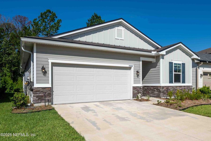 Front exterior of a new home in Tributary, Yulee, FL, highlighting curb appeal (Image 1). Front exterior of a new home in Tributary, Yulee, FL, highlighting curb appeal (Image 1).
