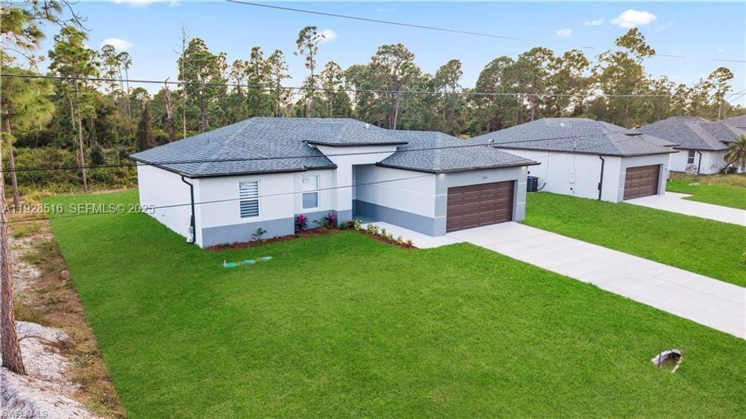 Front exterior of a new home in , Lehigh Acres, FL, highlighting curb appeal (Image 21).