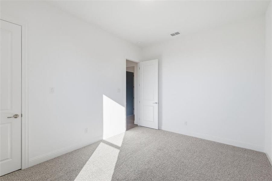 Carpeted empty room featuring baseboards Carpeted empty room featuring baseboards