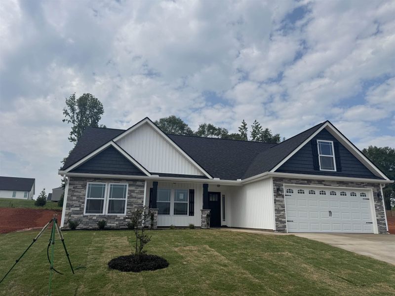 Front exterior of a new home in Ballentine Ridge, Lyman, SC, highlighting curb appeal (Image 1).