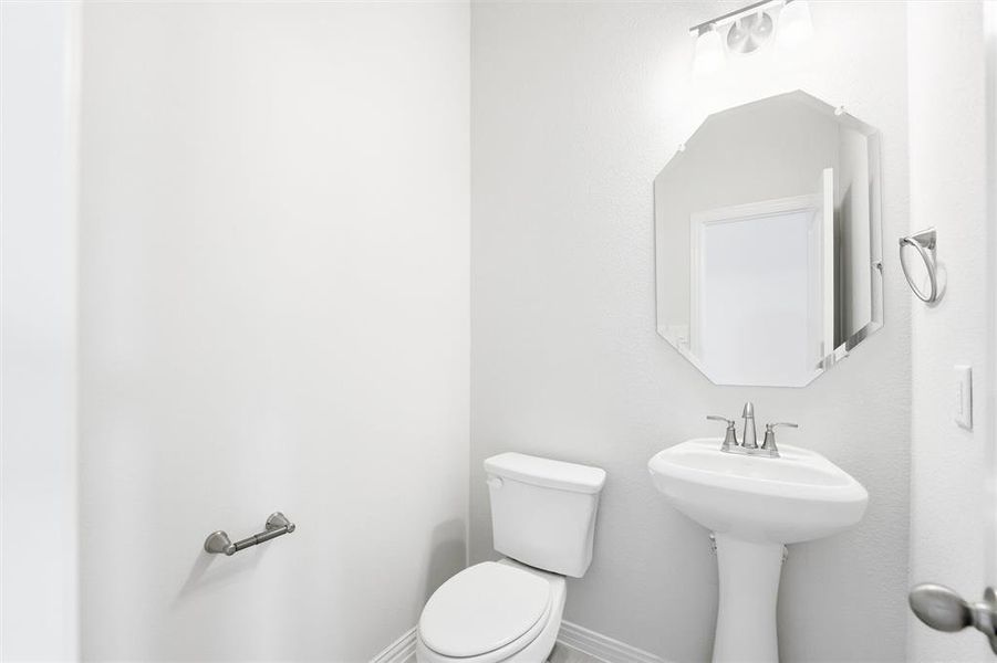 Bathroom featuring baseboards and toilet