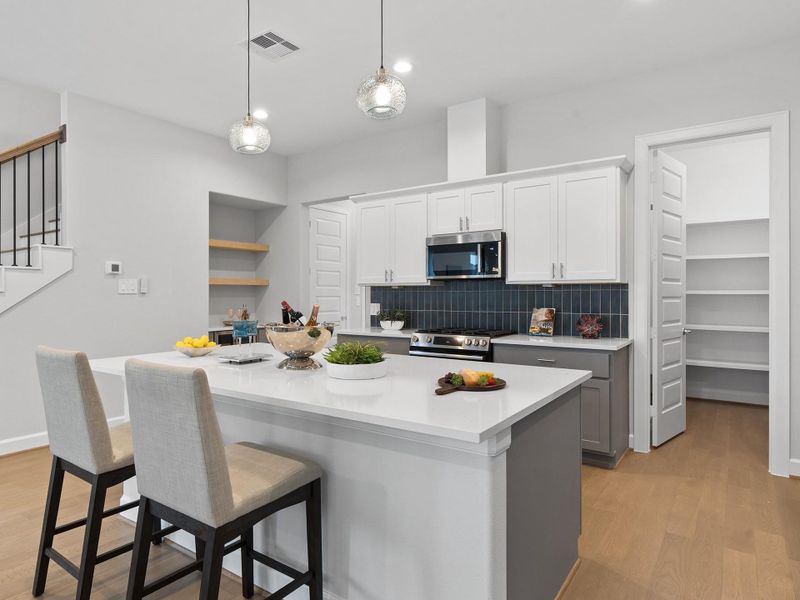 The thoughtfully designed ROCcreek kitchen blends modern style with everyday functionality, featuring designer finishes, abundant cabinetry, smart storage solutions, and an open-concept layout that flows effortlessly into the main living and dining areas. Perfect for entertaining or daily living, the kitchen offers a welcoming space at the heart of the home. Image depicts home as-is.