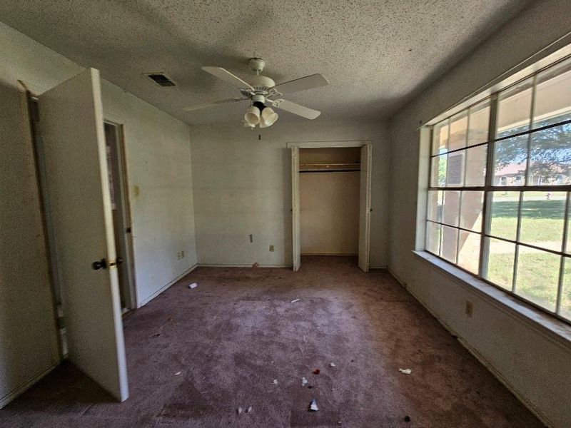 Unfurnished bedroom featuring carpet, a textured ceiling, a closet, and a ceiling fan Unfurnished bedroom featuring carpet, a textured ceiling, a closet, and a ceiling fan