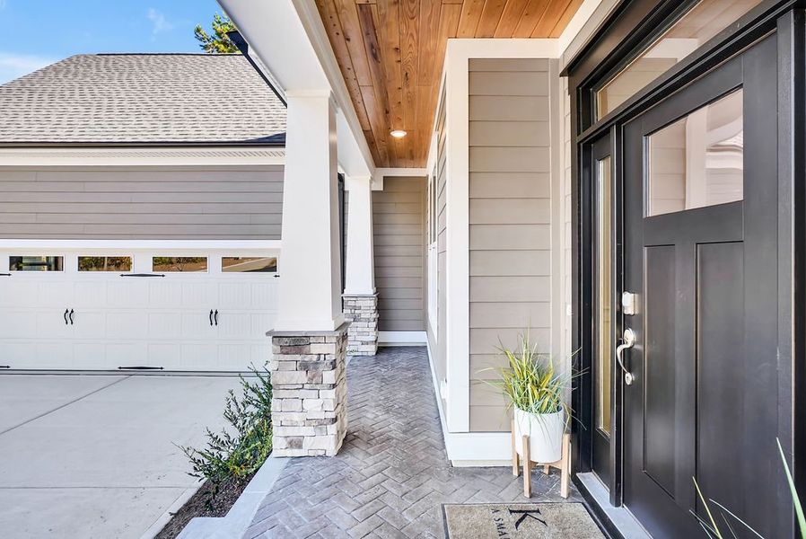 Exterior details and patio area of a home in The Bluffs On the Cape Fear, Leland (Image 3).