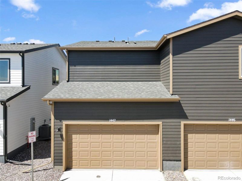 Front exterior of a new home in Spring Valley, Longmont, CO, highlighting curb appeal (Image 1).