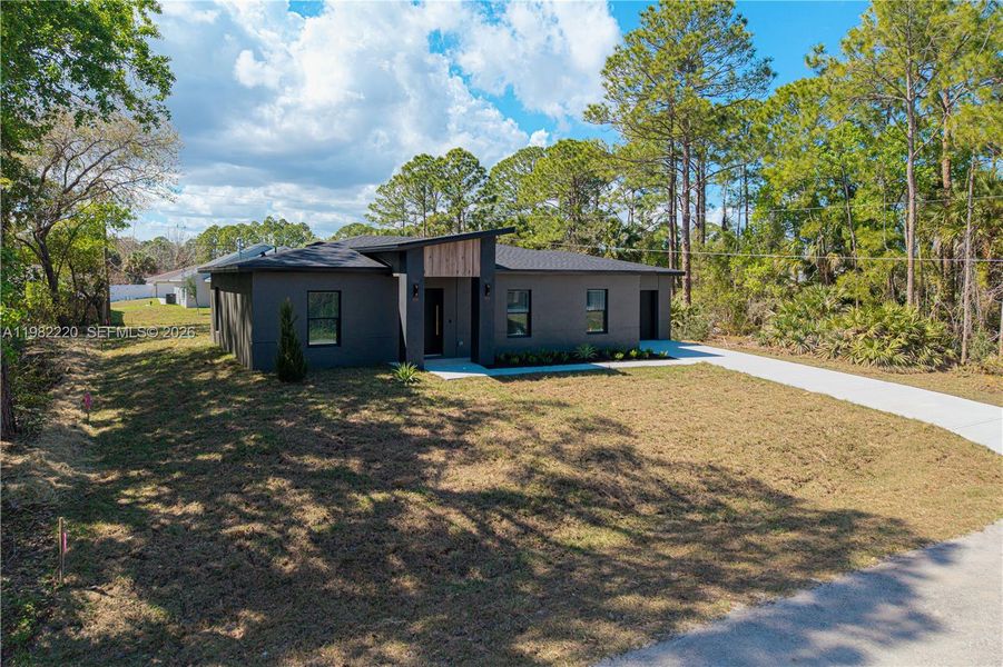 Front exterior of a new home in , Palm Bay, FL, highlighting curb appeal (Image 30).