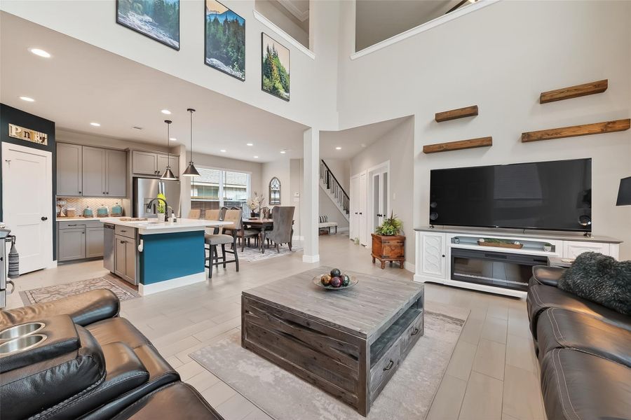 Living room open to the dining room, kitchen and upstairs game room
