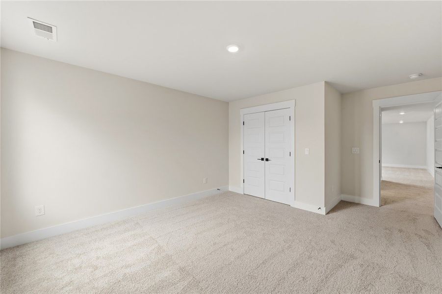 This versatile bedroom offers comfort and a blank