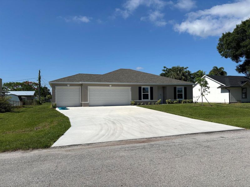 Front exterior of a new home in Port St Lucie, Port St. Lucie, FL, highlighting curb appeal (Image 1). Front exterior of a new home in Port St Lucie, Port St. Lucie, FL, highlighting curb appeal (Image 1).