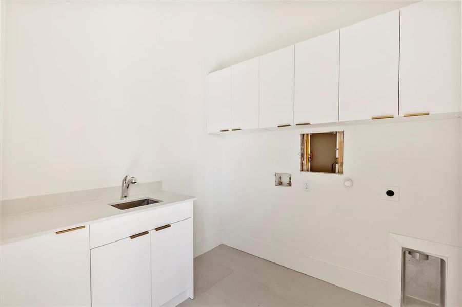 Laundry room featuring hookup for an electric dryer, cabinets, hookup for a washing machine, and sink