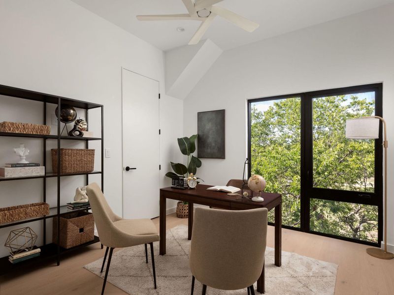 Large picture windows frame leafy views in this modern workspace.