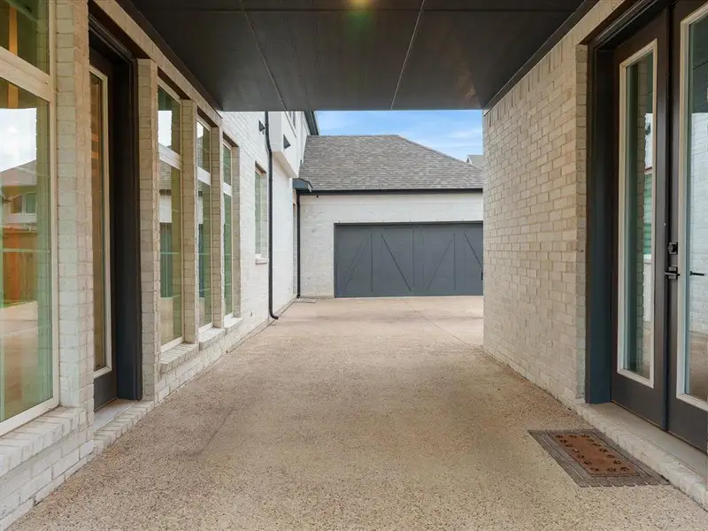 Covered walkway with light-colored brick exterior Covered walkway with light-colored brick exterior