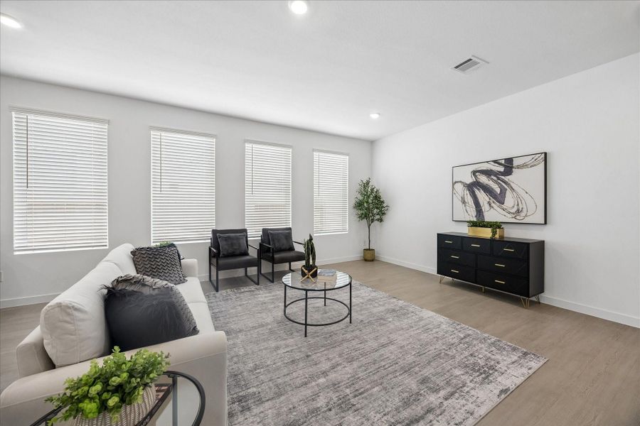 Stretch out, settle in and make yourself at home in this bright, open family room, where LVP flooring, fresh neutral finishes and an easy connection to the kitchen keep everyday living feeling effortless.