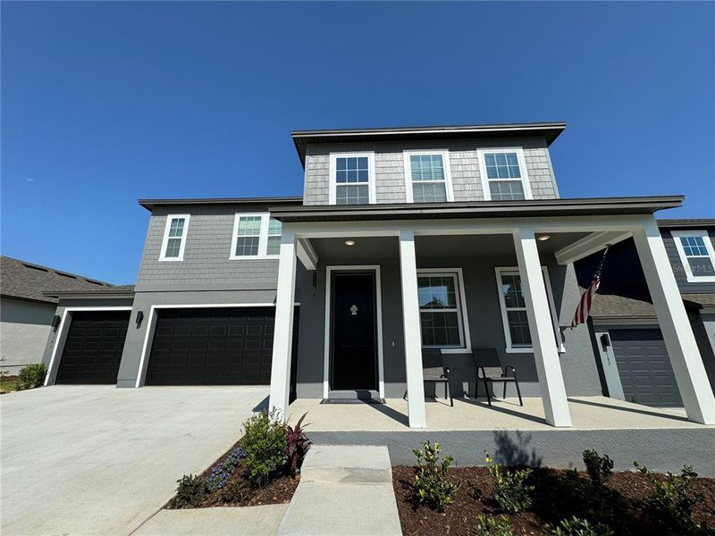 Front exterior of a new home in , Minneola, FL, highlighting curb appeal (Image 1). Front exterior of a new home in , Minneola, FL, highlighting curb appeal (Image 1).