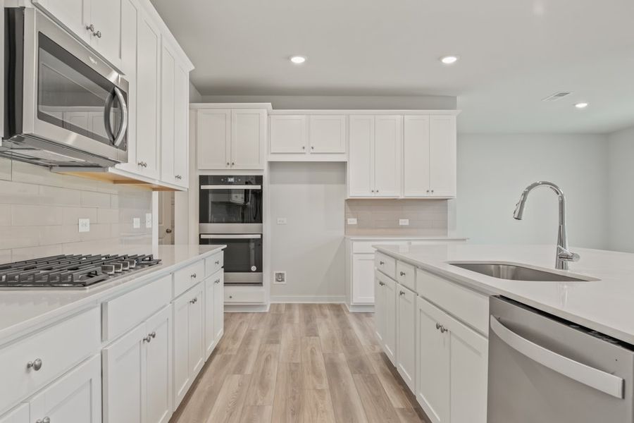 A kitchen with white cabinets.