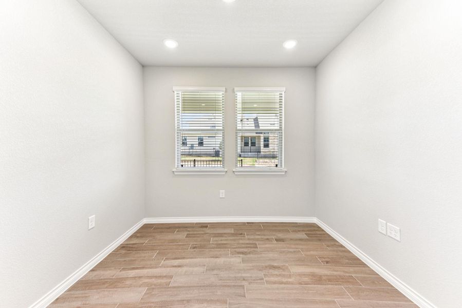 Unfurnished room with wood finish floors and recessed lighting Unfurnished room with wood finish floors and recessed lighting