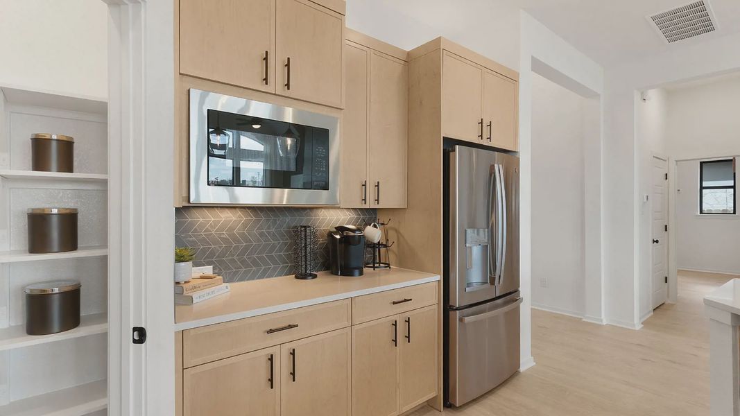 Representative furnished interior of a home built from the Mariah by Chesmar Homes in University Heights, Round Rock (Image 13).