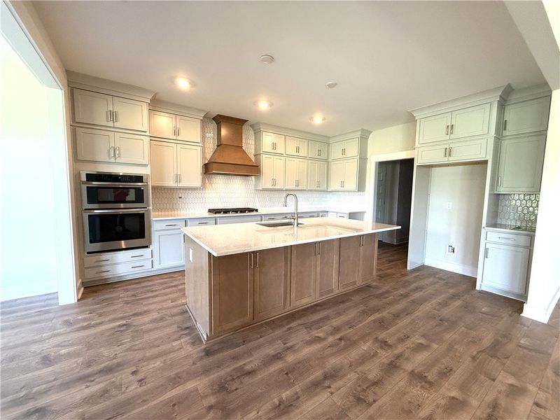 A grand central island anchors this pristine kitch A grand central island anchors this pristine kitch