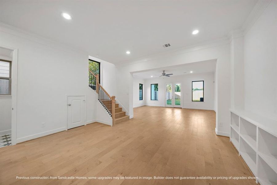 Elegant Ascension: The warm glow of wood floors not only grounds the dining room but also ascends, drawing the eye and spirit upward to the private sanctuaries above.