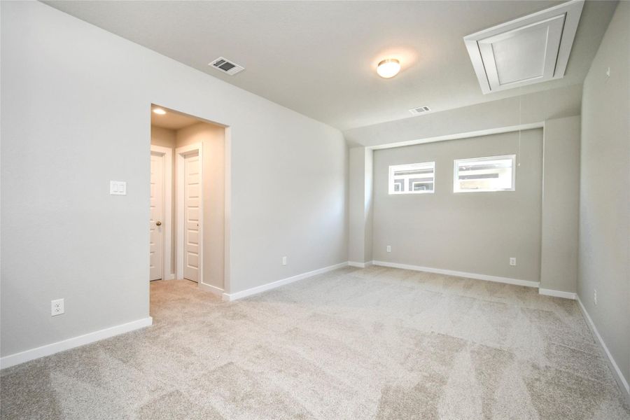 Come upstairs and enjoy a day of leisure in this fabulous game room! This is the perfect hangout spot or adult game room! Features plush carpet, high ceilings, custom paint and windows for plenty of natural light. Sample photo of completed home with similar floor plan. Actual colors and selections may vary.