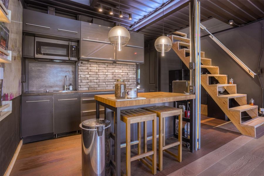 Kitchenette with two burner stove, microwave and dishwasher.