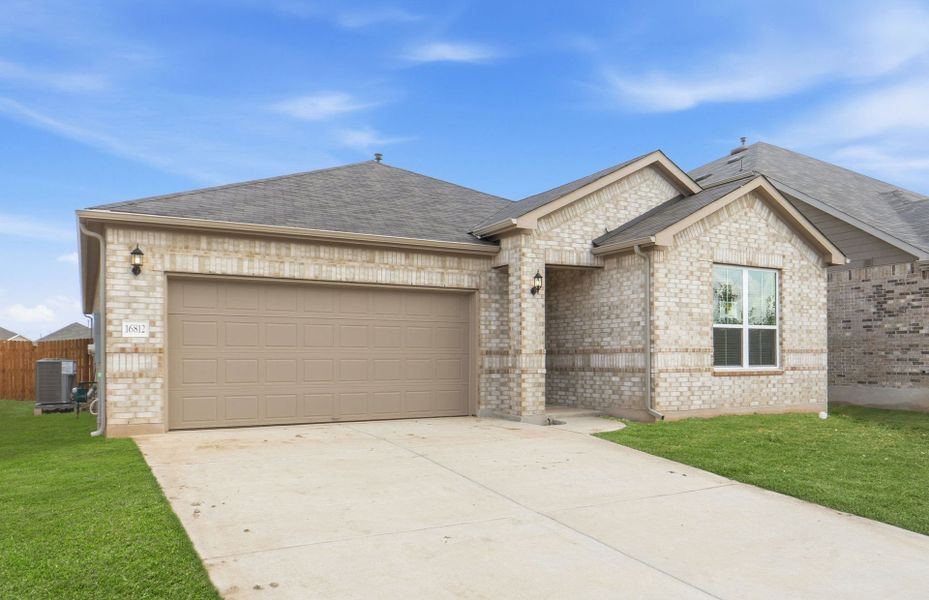 Front exterior of a new home in Lagos, Manor, TX, highlighting curb appeal (Image 20). Front exterior of a new home in Lagos, Manor, TX, highlighting curb appeal (Image 20).