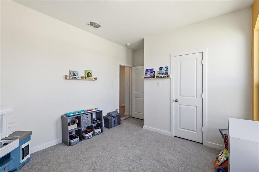Room featuring neutral wall finishes and light gray carpeting Room featuring neutral wall finishes and light gray carpeting