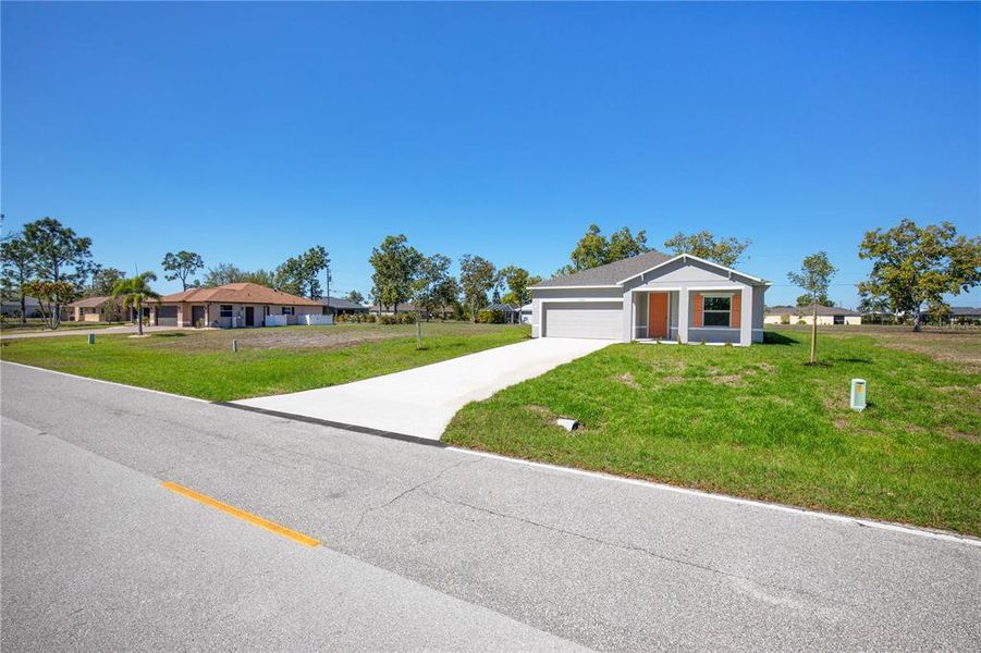 Front exterior of a new home in Burnt Store Village, Punta Gorda, FL, highlighting curb appeal (Image 11).