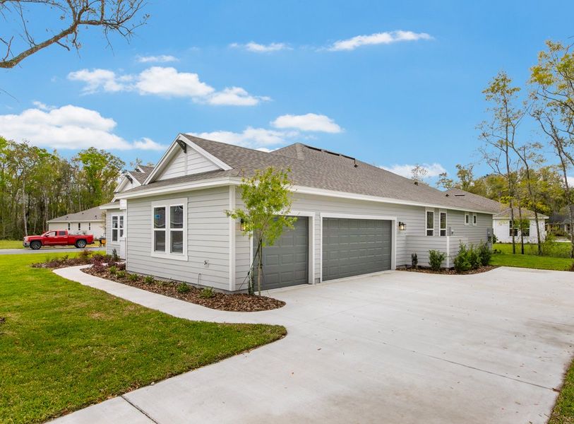 Front exterior of a new home in Osprey Cove, St. Marys, GA, highlighting curb appeal (Image 2). Front exterior of a new home in Osprey Cove, St. Marys, GA, highlighting curb appeal (Image 2).