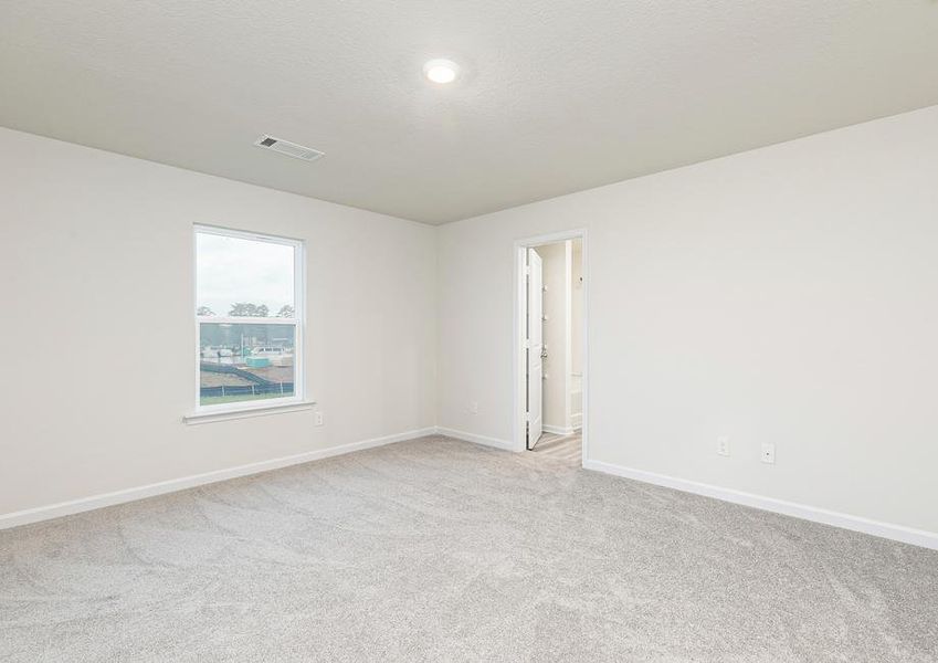 This spacious master bedroom is the perfect place to relax after a long day