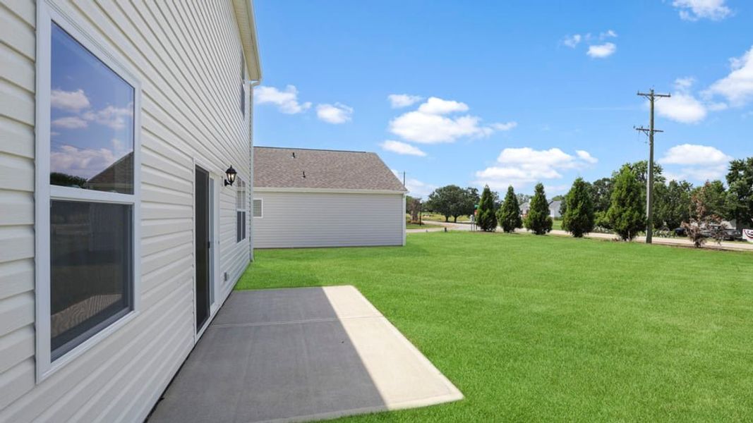 Exterior details and patio area of a home in Durbin Meadows Traditions, Fountain Inn (Image 22).