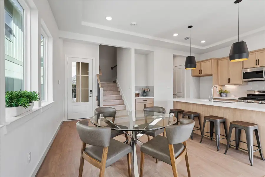 Dining positioned at the center of the first floor with clear sightlines to the kitchen and stairs, keeping the layout easy to read. Dining positioned at the center of the first floor with clear sightlines to the kitchen and stairs, keeping the layout easy to read.